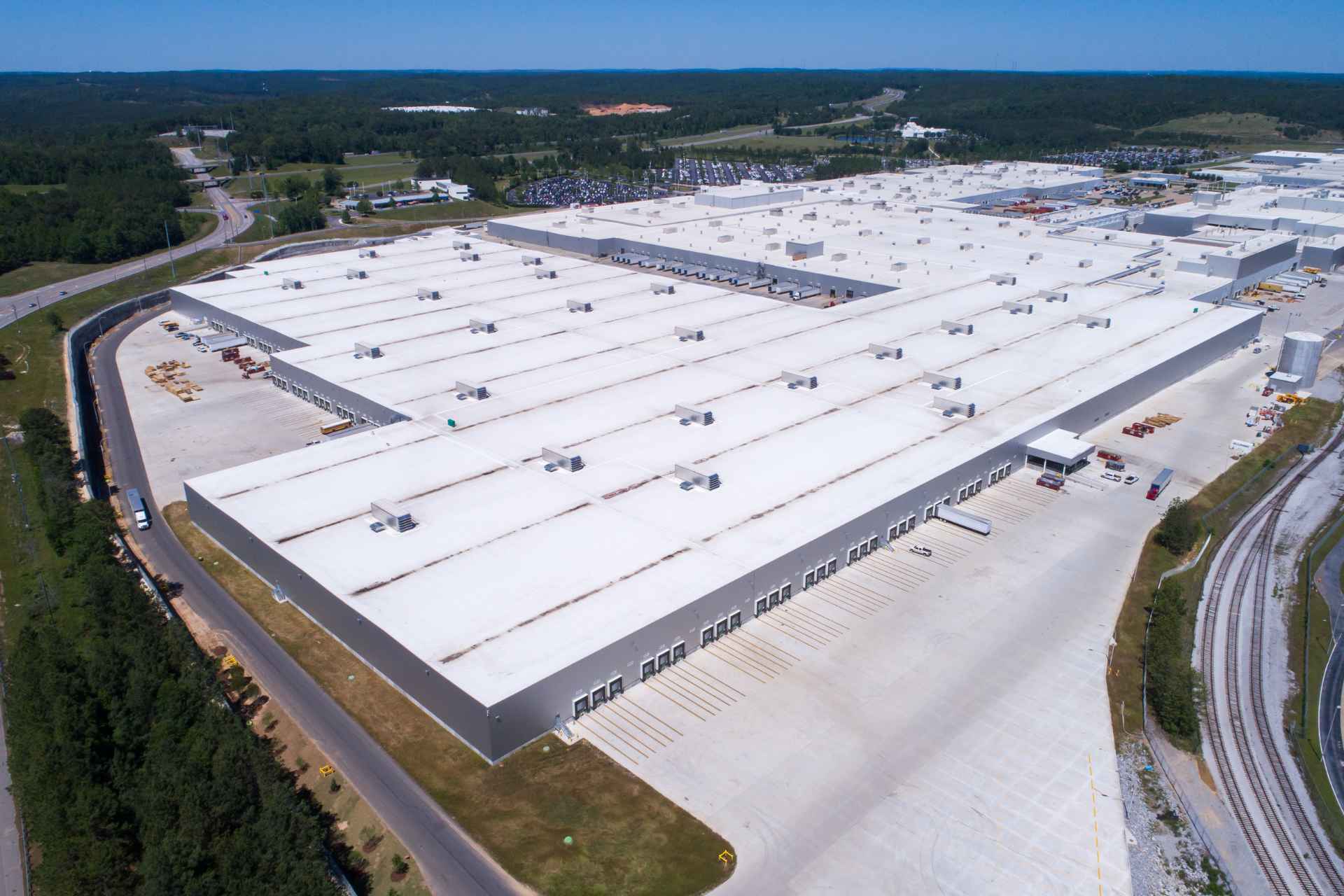 An expansive white flat roof of a huge factory.